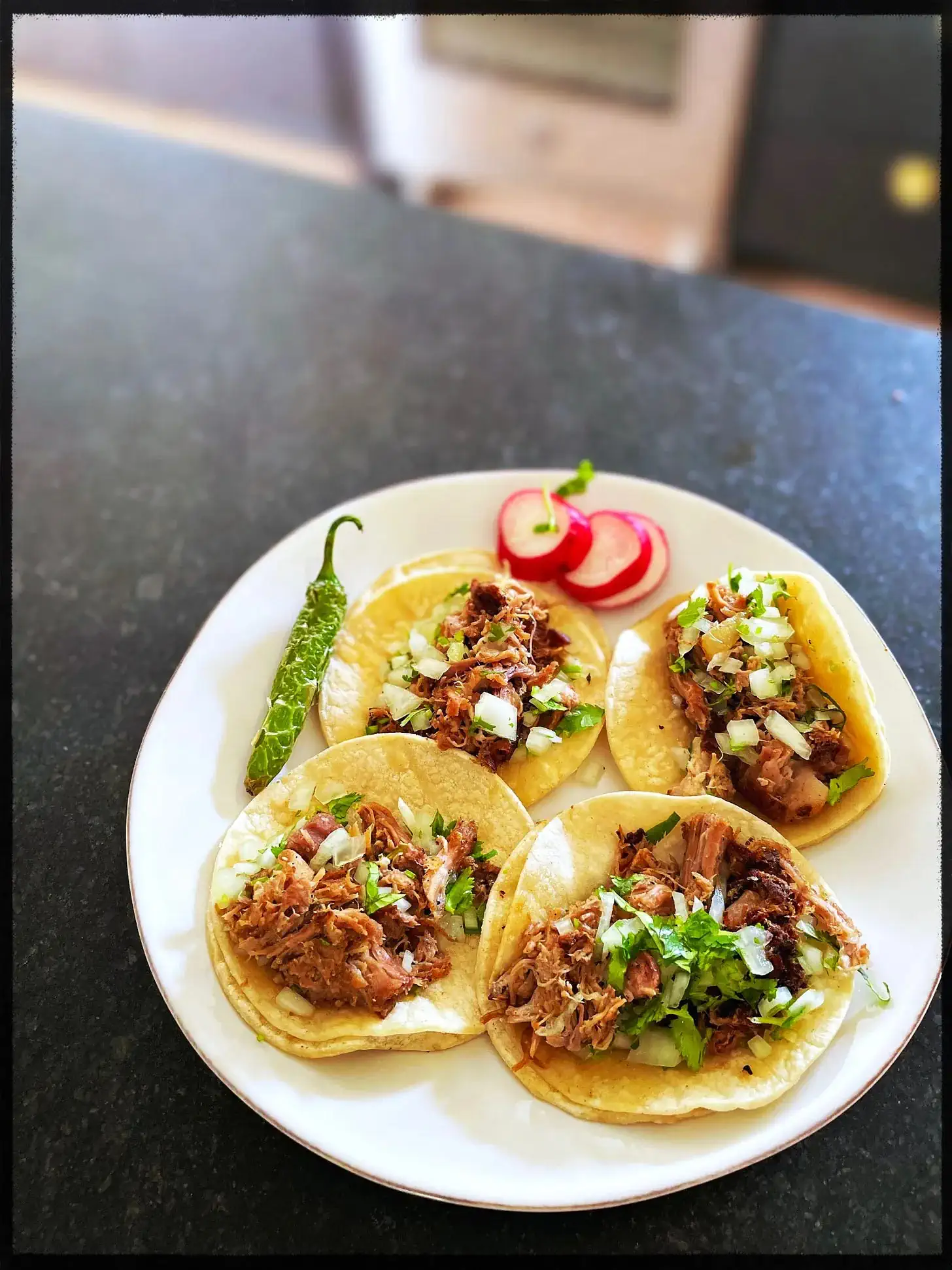 Four tacos on a plate